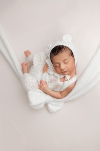 knitted newborn girl overalls in use.jpg