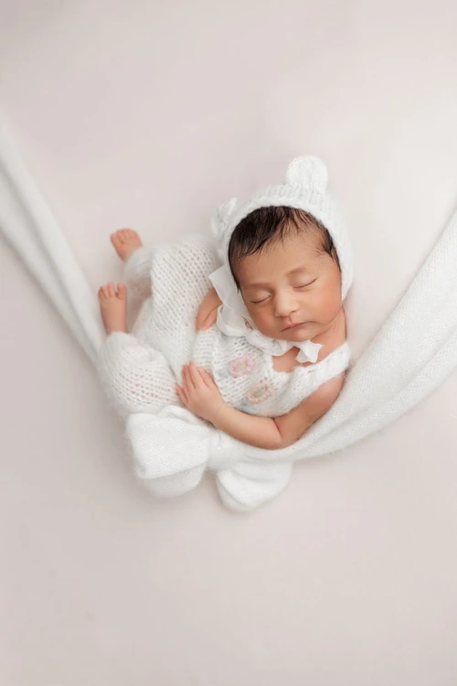 knitted newborn girl overalls in use.jpg